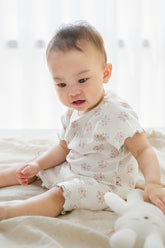 Baby wearing Sienna Rose Creamy Buquet short sleeve set, delicate pink and green floral print, comfortable summer baby outfit